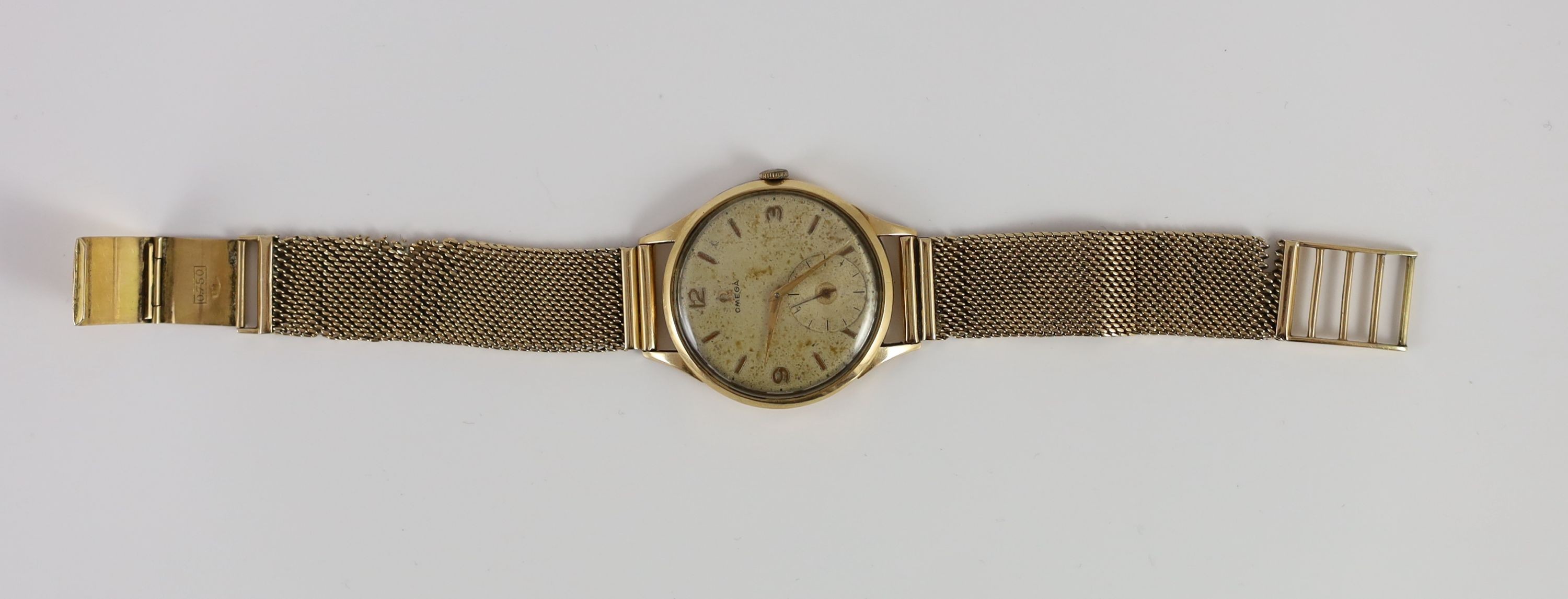 A gentleman's 1950's 18ct gold Omega manual wind wrist watch, on an Italian 750 yellow metal mesh link bracelet